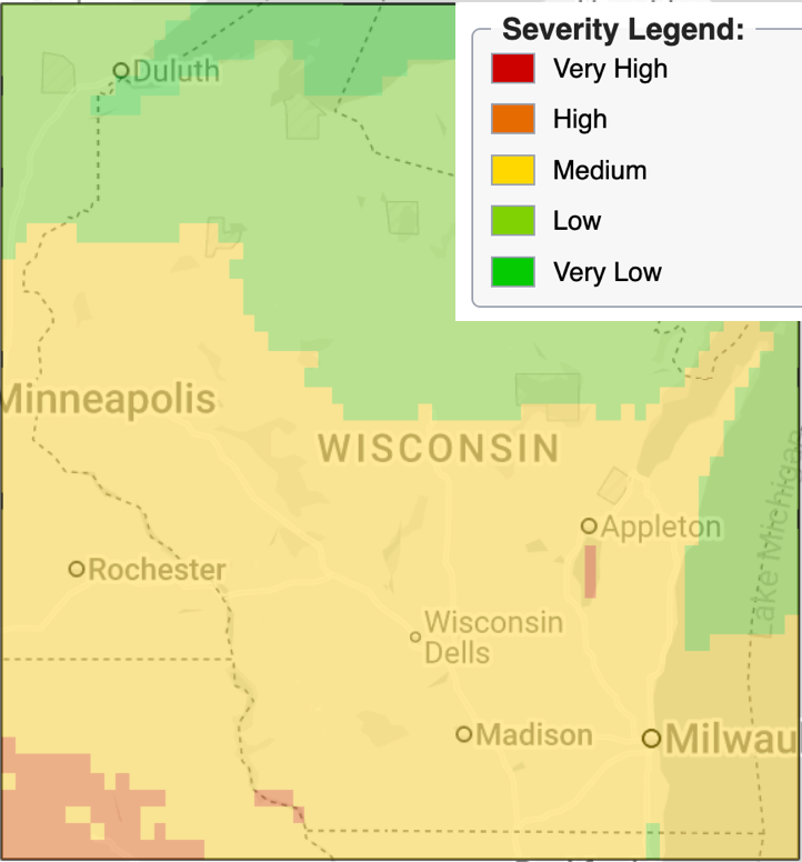 Display of Wisconsin with color-coded risk scores. The northeastern part of the state is green for "low risk", with a wave of yellow "medium risk" advancing from the southwest.
